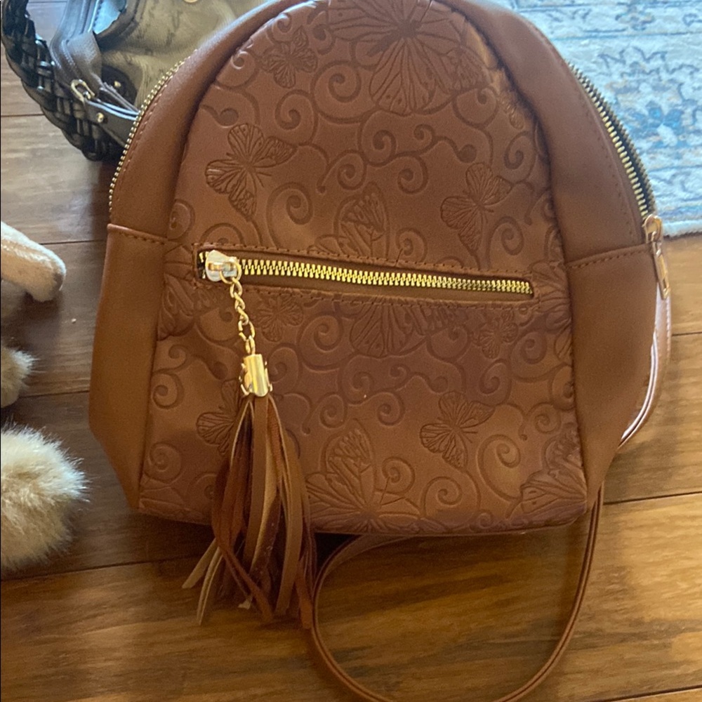 Brown Backpack with Embossed Pattern and Tassel